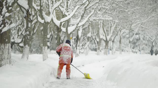 Sanitation workers are clearing snow in heavy winter snowfall