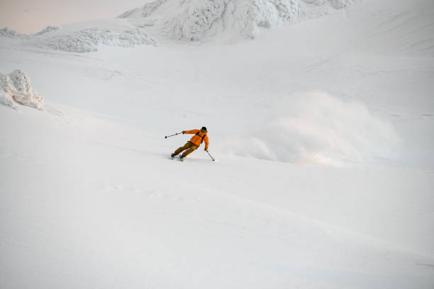 istock extreme male freerider skier quickly riding down on snow-covered mountain slope 1897009905