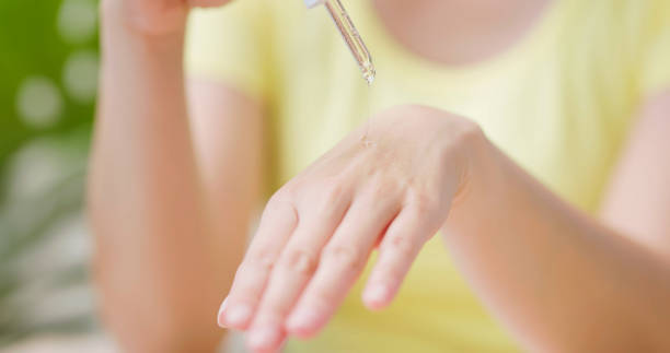 istock woman drop essence on hand 1897010199