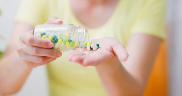 istock woman pour pills on hand 1897010728