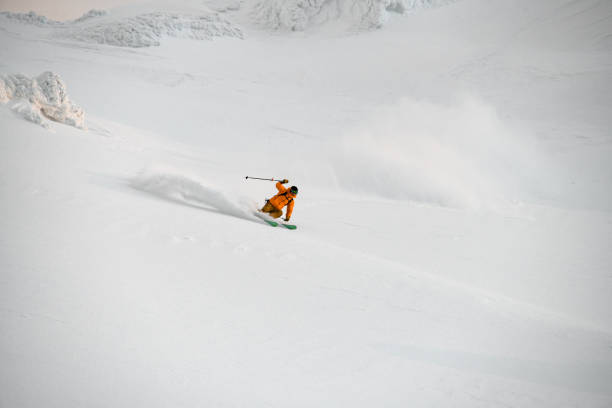 istock extreme freerider skier quickly riding down on snow-covered mountain slope 1897017579