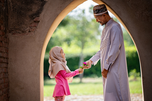 Muslim family, father and daughter in an old mosque.