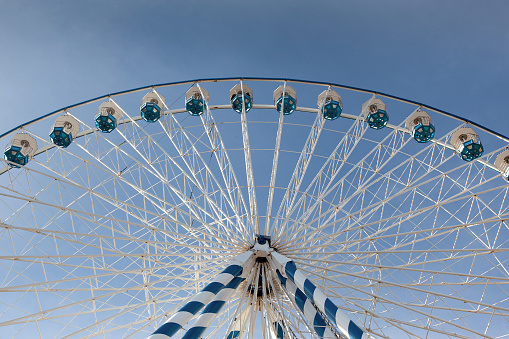 Ferris wheel and blue sky on background