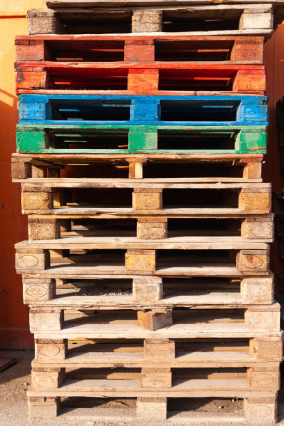 istock Multi-colored pallets stacked on top of each other. 1897083276