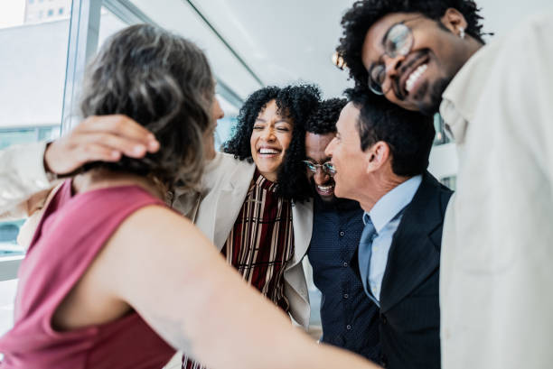 istock Coworkers embracing on the office 1897084625