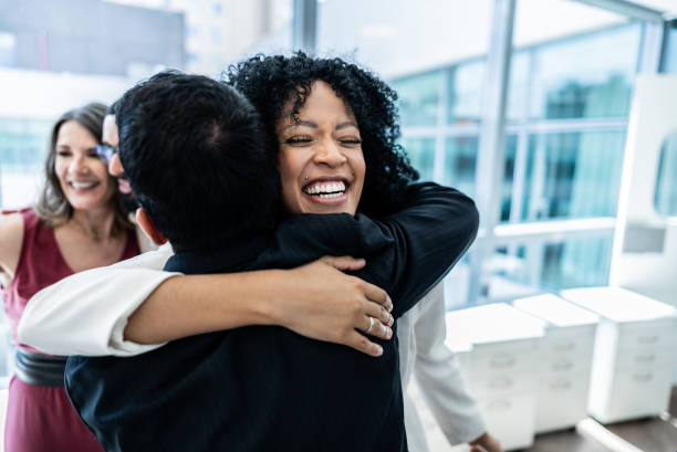 istock Coworkers embracing on the office 1897085135