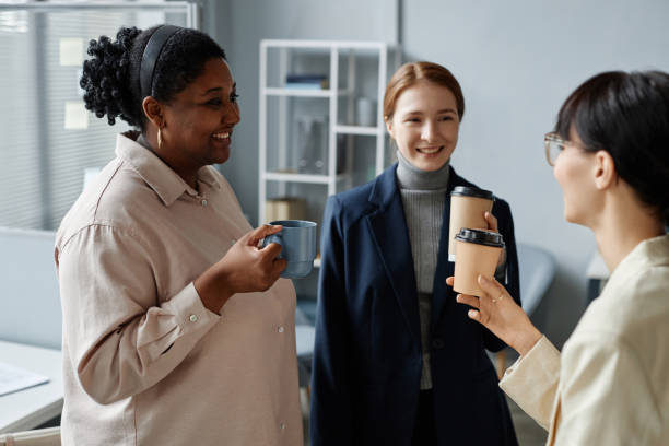 istock Smiling Female Coworkers Drinking Coffee at Office 1897108255