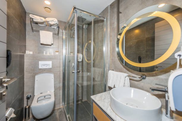 istock Modern bathroom has a round mirror, a large bath and a white towel 1897124132