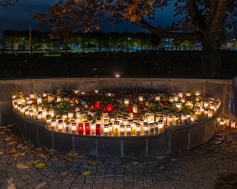 Grave candles on a cemetery on all saints eve.