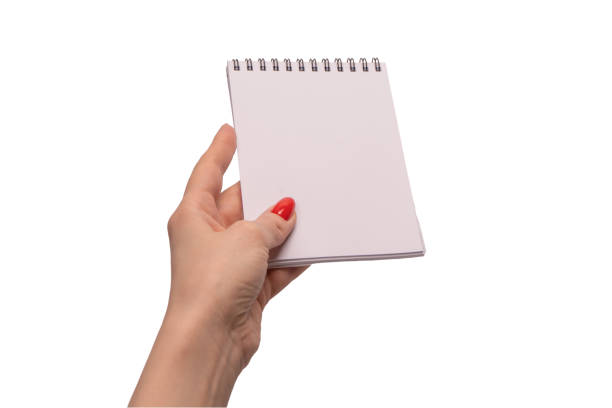istock A notebook with empty white paper in woman hands with red nails. 1897223669