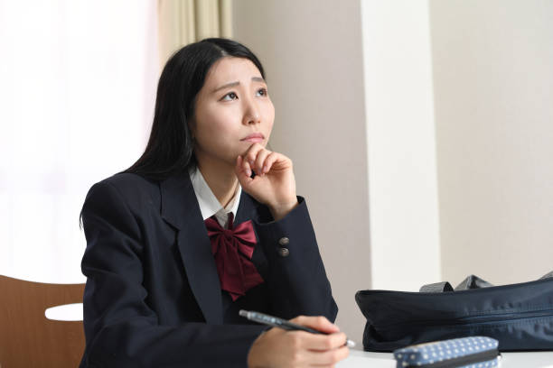 istock Profile of an Asian female student studying while worrying 1897306193