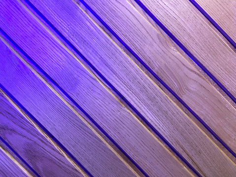 Neon colored and neon lighting reflection on wood texture background