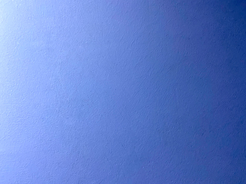 Blue background. Front view color gradient blue wall texture background with copy space