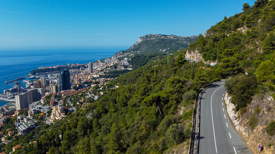 view of rich city of Montecarlo, tall buildings, narrow streets famous for formula 1 race. mountain, sea and beautiful city on a sunny day vacation and tourism in rich city with yachts and luxury cars