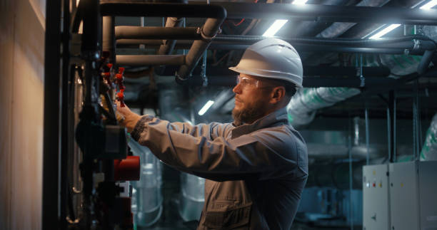istock Worker wearing safety uniform checks pipeline system 1897354396
