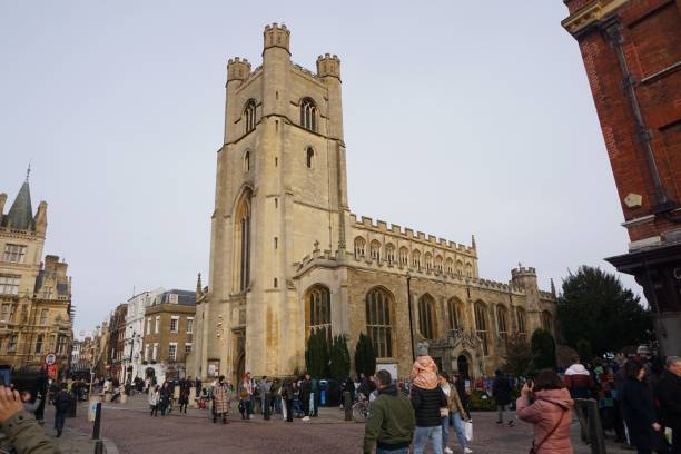 Cambridge, England - 26 December 2023: A number of tourists are walking on the street outside St Mary's church in Cambridge in late December