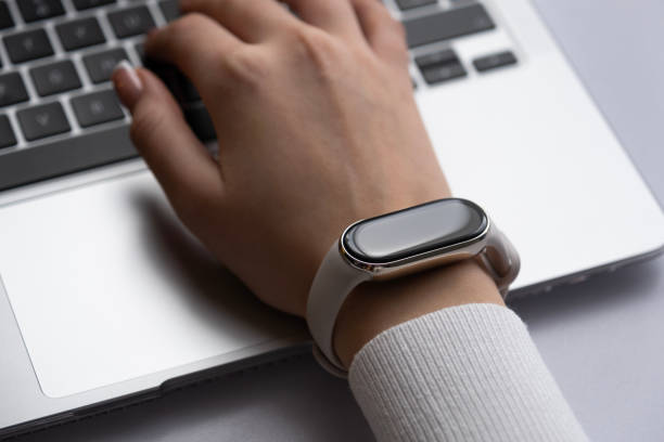 istock Woman working on a laptop with a smart watch on a wrist 1897428292