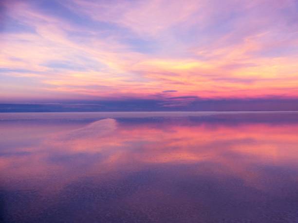 istock Colorful sunset sky clouds over lake 1897469899