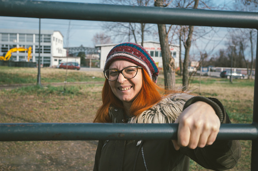 Happy woman wearing knit hat posing outdoors