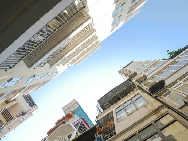 istock Looking up view multistory apartment building with caged-balcony, small back alley in downtown Hanoi, Vietnam, row of condo blocks with outside air conditioner unit urban population density 1897563033