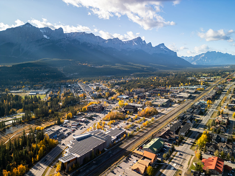 Aerial view of Town of Canmore in a autumn sunny day. Canadian Rockies mountain range in the background. Alberta, Canada.