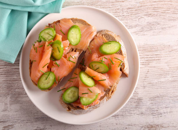 istock salmon with cucumbers over slices of brown bread 1897614230