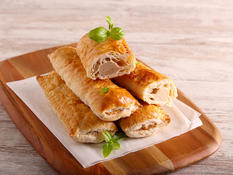 Sausage rolls on wooden board