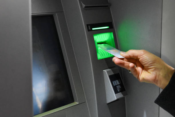 istock withdrawing cash at an ATM 1897627912
