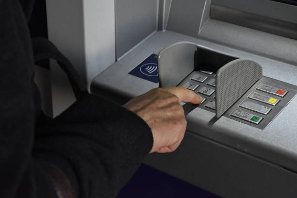 istock withdrawing cash at an ATM 1897631506