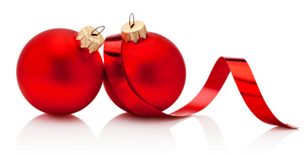 istock Two red Christmas baubles and curling paper Isolated on white background 1897652506