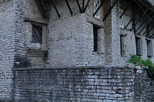 Corner of a traditional, well-preserved, three-storey Ottoman house with defensive wall dating from the early 1700s, the richest in the city, in the upper part of the old town. Gjirokaster-Albania.
