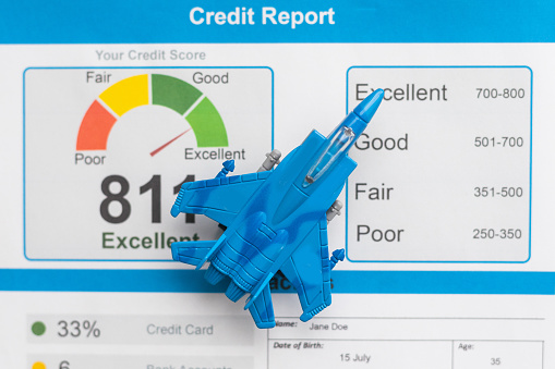 Credit score report document and toy plane on desk. High quality photo