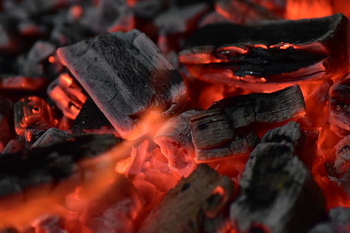 Macro close up of the glowing embers of a wood bonfire