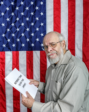 An unhappy senior adult man is reading a simulated USA Social Security and/or financial planning information document titled: \