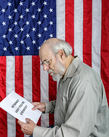 An shocked and disturbed senior adult man is reading a simulated USA Social Security information and/or financial planning document titled: \