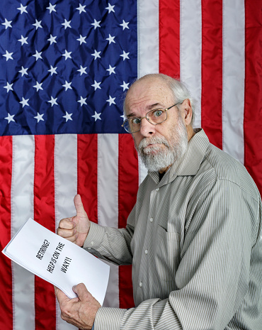 A senior adult man showing a thumbs up hand gesture is reading a simulated USA Social Security and/or financial planning information document titled: 