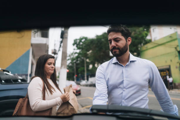 istock Couple putting purchases in the car trunk 1898069250