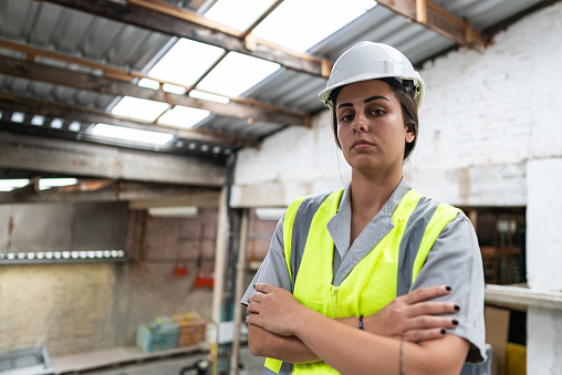 Portrait of a young woman working on a project construction