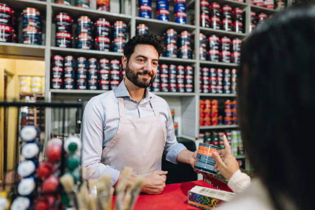 istock Salesman talking to customer at paint store 1898172279