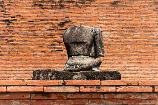 broken Buddha statue without head. historical sights of Thailand. Ayutthaya is the ancient ruined capital of Siam.