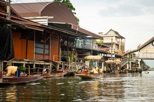 Famous floating market in Thailand, Damnoen Saduak floating market, tourists visiting by boat, Ratchaburi, Thailand. July 5, 2023