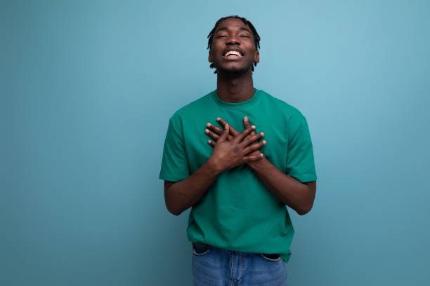 istock funny laughing american young guy in a t-shirt on a blue background 1898212866