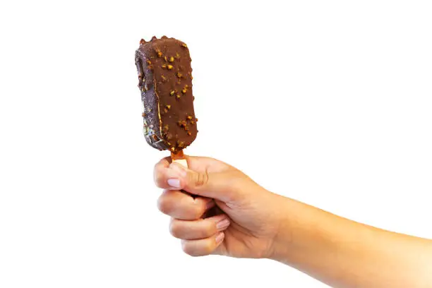 Photo of Ice cream covered with chocolate and almonds sticks in hand isolated white background.