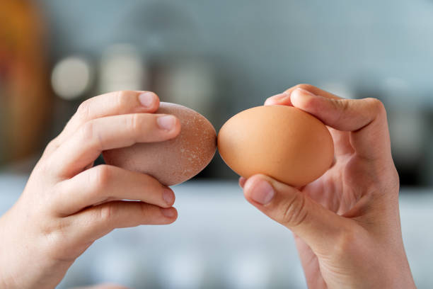 istock Hands holding easter eggs for battle. old Christian Orthodox tradition of beating colorful eggs at Easter. 1898219328