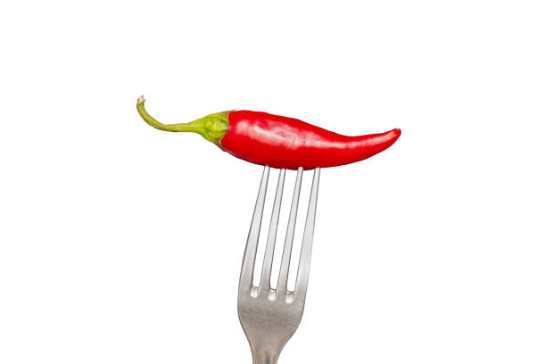 istock Fork with chili pepper isolated on white. hot pepper 1898219329