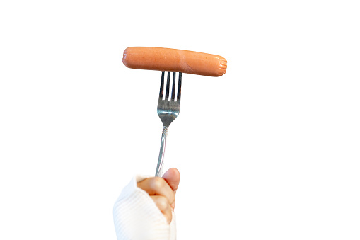 Female hand hold fork with sausage, isolated on white background
