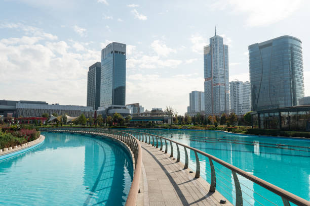 Awesome view of contemporary buildings reflected in pool of Tashkent City Park in Tashkent, Uzbekistan. The park is a popular recreational gathering place among residents and tourists. Awesome view of contemporary buildings reflected in pool of Tashkent City Park in Tashkent, Uzbekistan. park is a popular recreational gathering place among residents and tourists. tashkent stock pictures, royalty-free photos & images