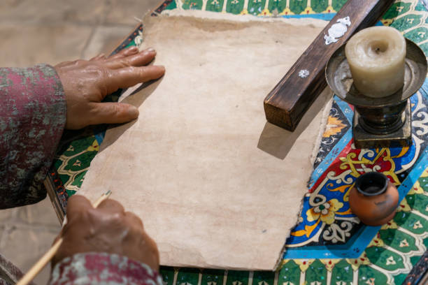 istock an empty sheet on a writing table in medieval Arabic style. Mid-lateral writing set with pen 1898224252