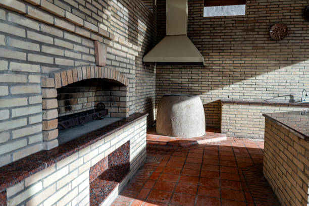 Fireplace with grill and lit fire for roasting food and meat in the garden