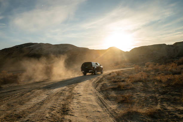 Concept travel offroad with car 4x4. A black pickup truck is climbing uphill on a dirt road. A black pickup truck is climbing uphill on a dirt road. Concept travel offroad with car 4x4 jeep off road stock pictures, royalty-free photos & images